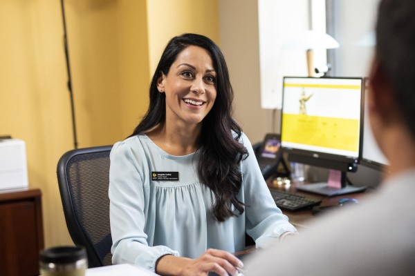 An employee talks to a student